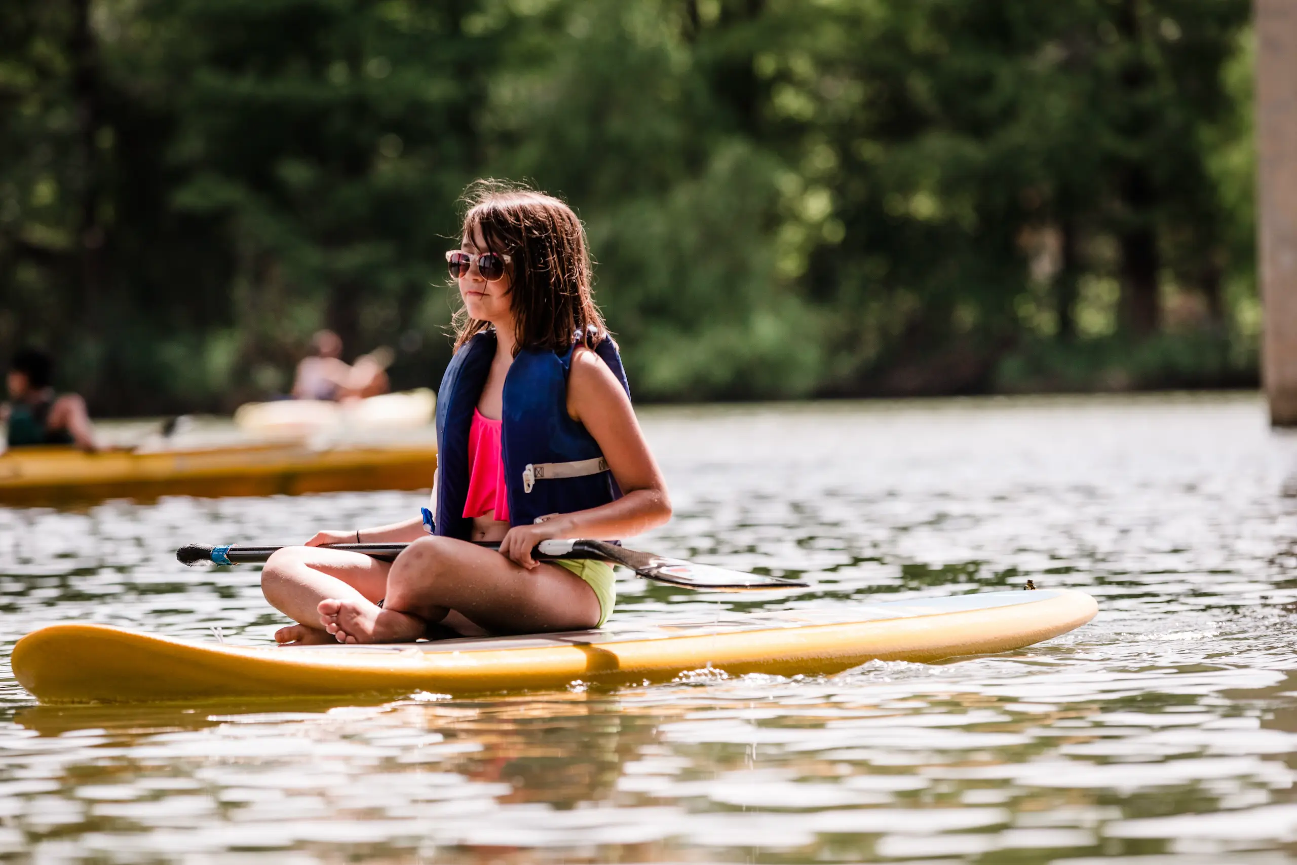 Photo of a young girl on a paddleboard