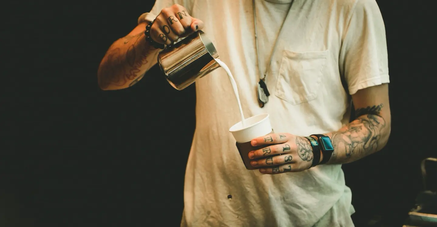 Photo of a barista pouring coffee